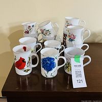 Group of 13 mugs showing decorative patterns and condition