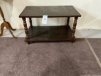 Full view of side table showing two tiers and turned legs