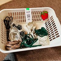 Overview of basket with extension cords and strawberry decoration