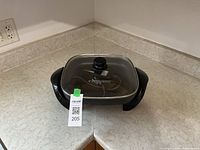 Electric skillet with glass lid and control probe resting inside