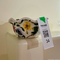 Overall view of ceramic planter showing floral design and shape