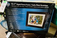 Retail package of HP 12.1-inch digital picture frame df1208a showing features and size