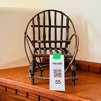 Front view of miniature twig chair with MaxSold lot tag