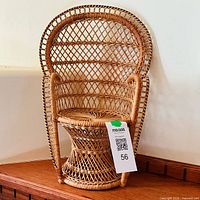 Front view of wicker doll chair with lattice back and pedestal seat