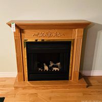 Front view of electric fireplace showing wood mantel and insert