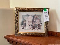 Front view of framed bathroom print in ornate gold frame