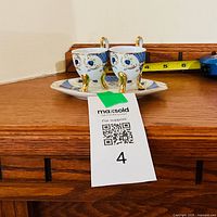 Front view of both miniature teacups and tray showing pattern and scale