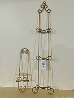 Both gold metal display stands, large and small, front view