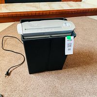 Front view of paper shredder showing bin, head, cord and control knob