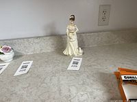 Front view of Royal Doulton Country Girl figurine on countertop