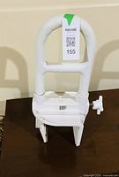 Overall view of white clamp-on bathtub grab rail on table