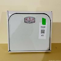 Front view of boxed analog bathroom scale