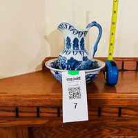 Pitcher and bowl together with measuring tape showing scale