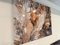 Front view of wall art showing feather design and color palette