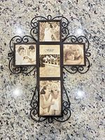 Front view of metal cross picture frame with sample photos inserted