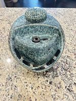 Top view showing round cap and water outlet opening