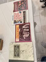 All four books stacked on table, spines visible