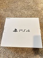 White Sony outer box top view with PS4 logo