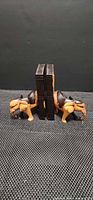 Front view of both elephant bookends supporting books
