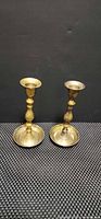 Front view of both brass candlesticks showing overall design and height