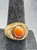 Front view showing tiger’s eye cabochon and gold setting