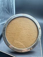 Front view of round frame showing silver rim and aperture