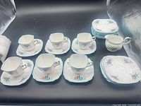Full set overview showing cups, saucers, plates and creamer