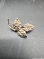 Front view of silver leaf brooch