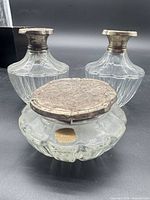 Three crystal containers with sterling silver lids