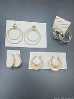 All four pairs of hoop earrings displayed on cards