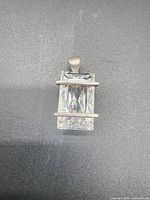 Front view showing large faceted stone and silver bars