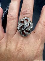 Ring on hand showing top design and scale