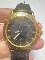 Front view showing dial, subdials, tachymeter bezel and leather strap