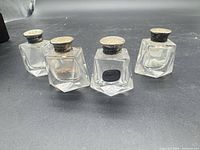 All four crystal shakers with sterling caps displayed