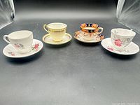 Group shot of four teacup and saucer sets displayed side by side