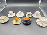 Group of eight assorted demitasse cup and saucer sets
