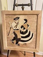 Full view of cowhide folk art wall hanging on easel