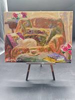 Full view of signed oil painting on canvas displayed on small easel