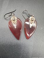 Front view of both earrings showing amber stones and silver accents