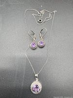 Full view of earrings, pendant and chain