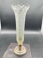 Full view of crystal vase on silver base