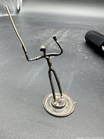 Front view of sterling silver figurine showing pose and base