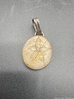 Front view of sterling silver pendant showing fossil star pattern