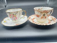 Both cup and saucer sets side by side