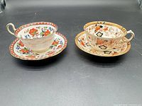 Both teacup and saucer sets side by side