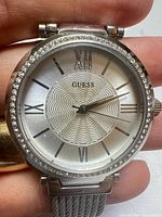 Front view showing dial, crystal bezel, mesh band