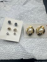 Overview of all four pairs of earrings on cards
