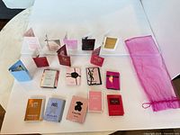 All 18 fragrance sample cards laid out with bag visible