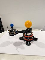 Full view of assembled orbit model showing sun, earth and base