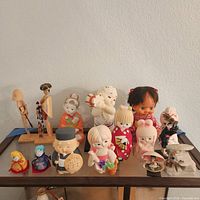 Entire assortment of dolls and figurines on display shelf